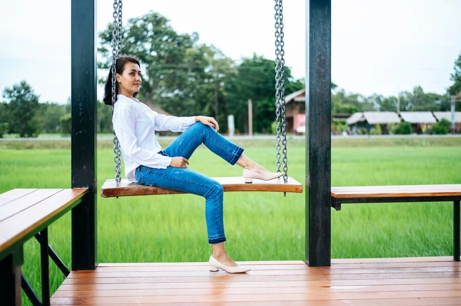 Girl enjoying benefits of pergola in backyard