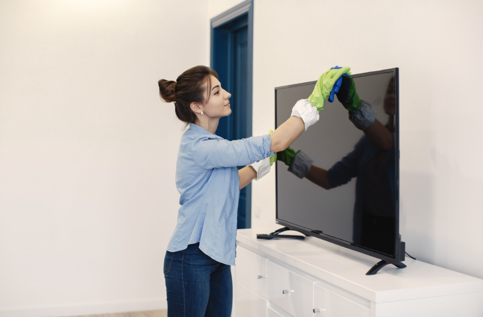 A woman using idea for placing tv inside kitchen with gloves ON